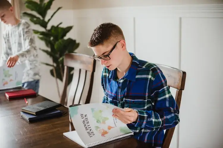 Child flipping through The Book of Centuries