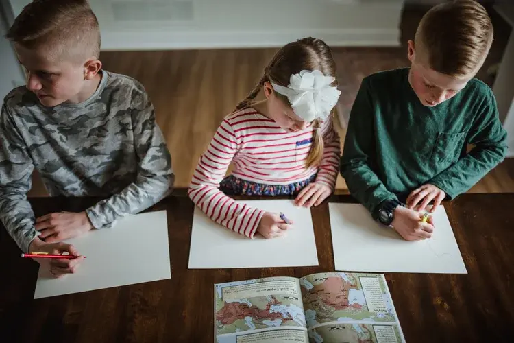Kids drawing at table
