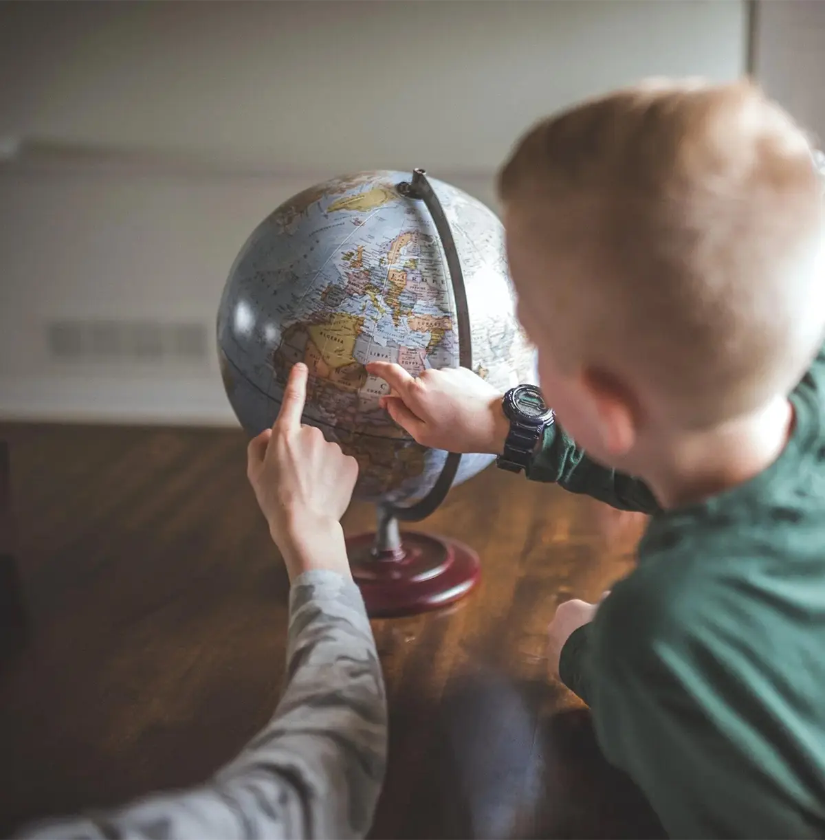 Child interacting with globe